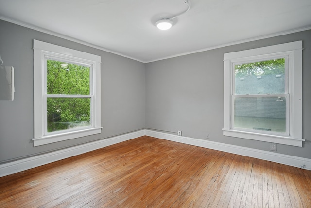 3114 School St, Des Moines, IA 50311 - spare room with crown molding, plenty of natural light, hardwood / wood-style floors, and baseboards