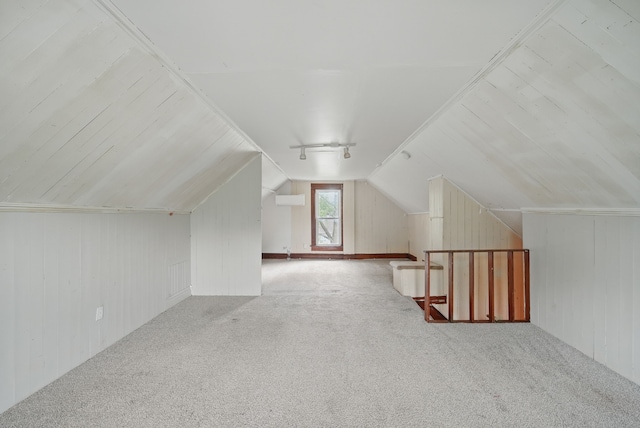 3114 School St, Des Moines, IA 50311 - additional living space with carpet floors, vaulted ceiling, and wood walls