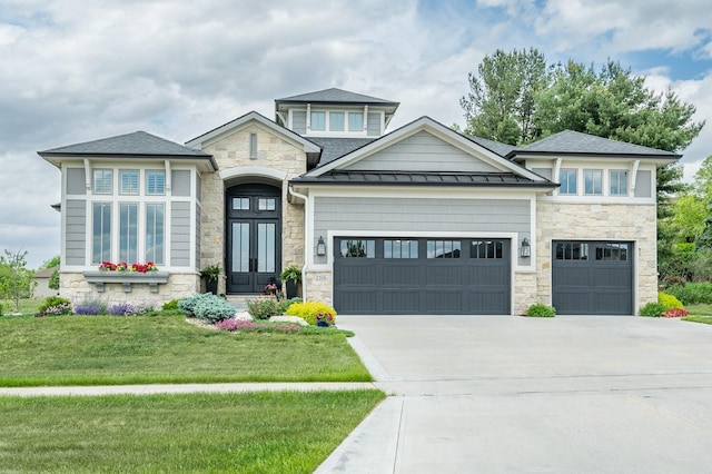 2315 14th St SW, Altoona, IA 50009 - view of front of house with stone siding, french doors, concrete driveway, a garage, and a front lawn