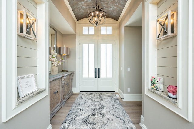 2315 14th St SW, Altoona, IA 50009 - entrance foyer featuring lofted ceiling, light wood-type flooring, baseboards, and a chandelier