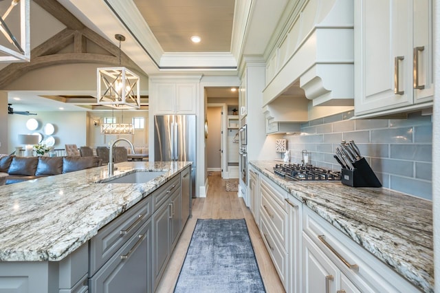 2315 14th St SW, Altoona, IA 50009 - kitchen with a sink, gray cabinetry, a chandelier, crown molding, and backsplash