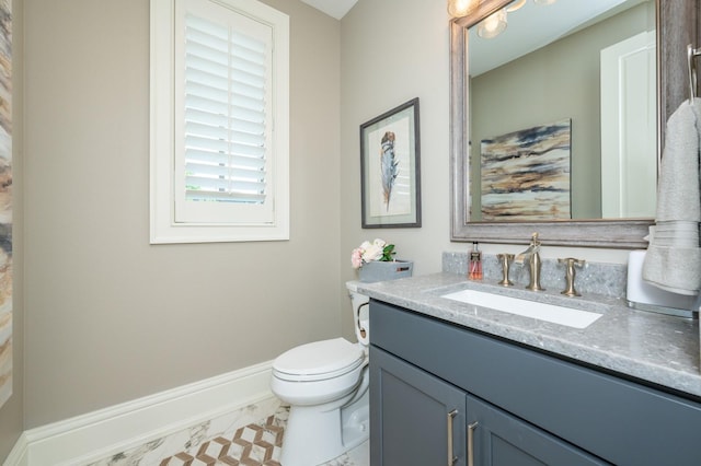 2315 14th St SW, Altoona, IA 50009 - bathroom featuring vanity, toilet, and baseboards