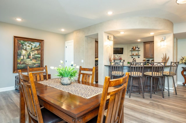 2315 14th St SW, Altoona, IA 50009 - dining room with light wood-style floors, baseboards, bar area, recessed lighting, and arched walkways