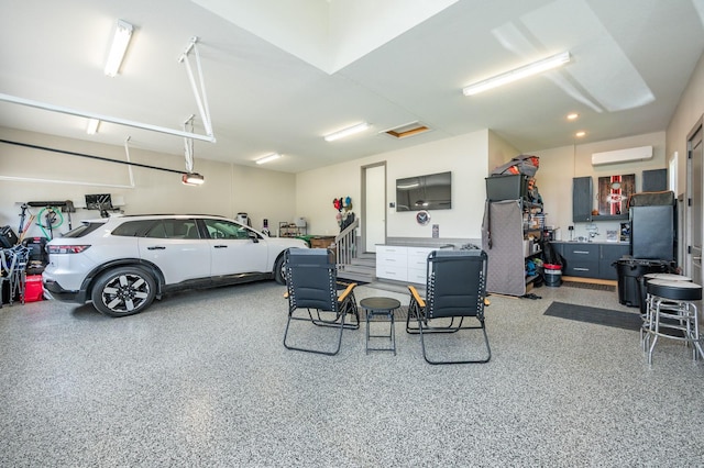 2315 14th St SW, Altoona, IA 50009 - garage featuring an AC wall unit and a garage door opener