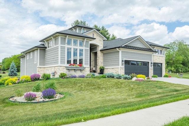 2315 14th St SW, Altoona, IA 50009 - view of front of house featuring stone siding, a garage, a front yard, and driveway