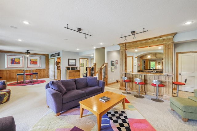 1176 Glen Oaks Dr, West Des Moines, IA 50266 - living area with light carpet, recessed lighting, ceiling fan, ornate columns, and rail lighting