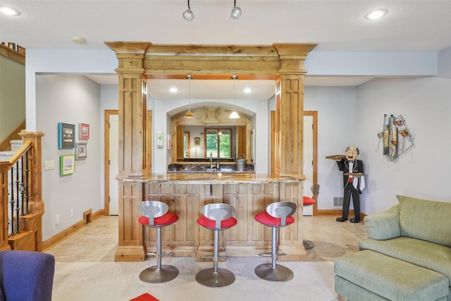 1176 Glen Oaks Dr, West Des Moines, IA 50266 - indoor wet bar featuring recessed lighting, pendant lighting, baseboards, and decorative columns