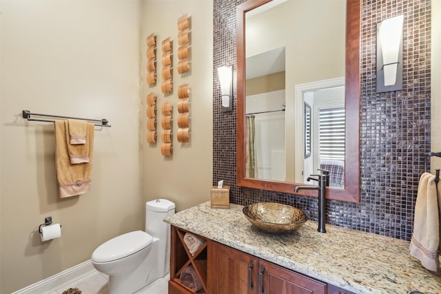 1176 Glen Oaks Dr, West Des Moines, IA 50266 - bathroom with backsplash, vanity, toilet, baseboards, and a shower