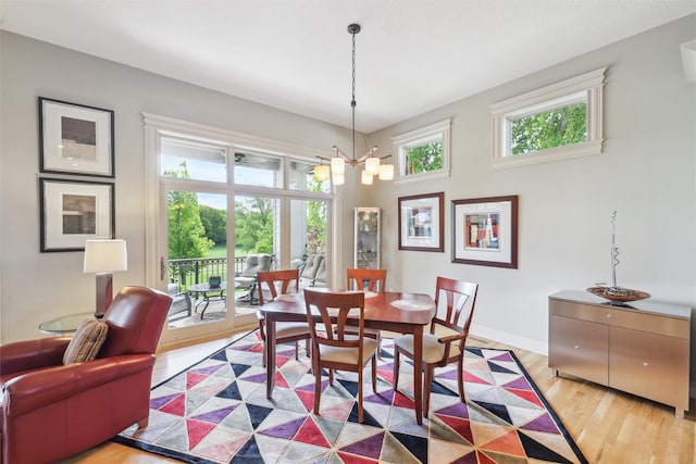 1176 Glen Oaks Dr, West Des Moines, IA 50266 - dining room with a chandelier, light wood-type flooring, and baseboards