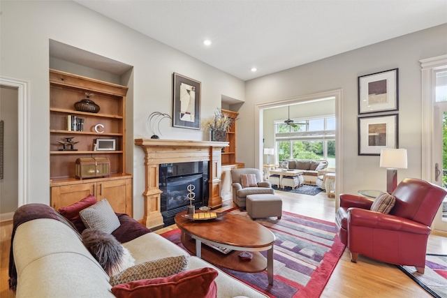 1176 Glen Oaks Dr, West Des Moines, IA 50266 - living area with light wood-style flooring, a fireplace with flush hearth, and recessed lighting