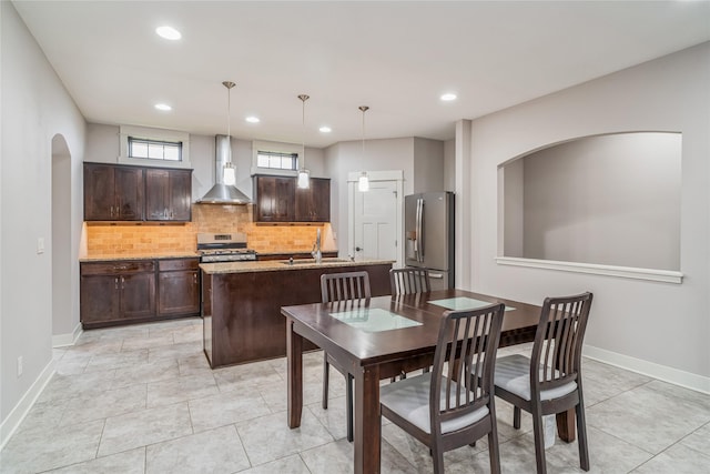 2658 SW 20th Cir, Ankeny, IA 50023 - dining area featuring recessed lighting, baseboards, light tile patterned floors, and arched walkways