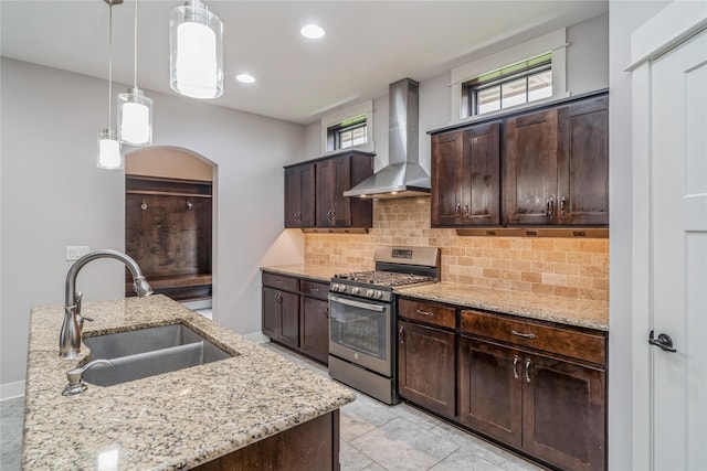 2658 SW 20th Cir, Ankeny, IA 50023 - kitchen featuring stainless steel gas range oven, wall chimney exhaust hood, a sink, decorative backsplash, and recessed lighting