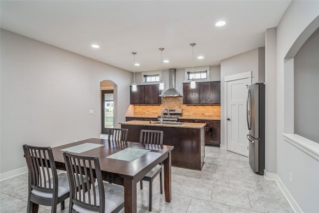 2658 SW 20th Cir, Ankeny, IA 50023 - dining area featuring arched walkways, recessed lighting, light tile patterned flooring, and baseboards