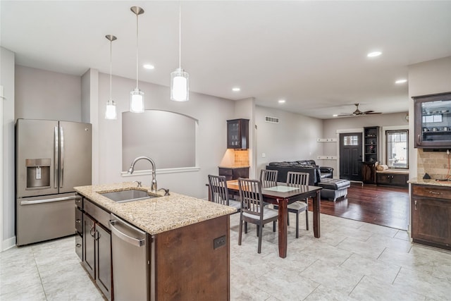2658 SW 20th Cir, Ankeny, IA 50023 - kitchen with appliances with stainless steel finishes, a sink, a ceiling fan, dark brown cabinets, and recessed lighting