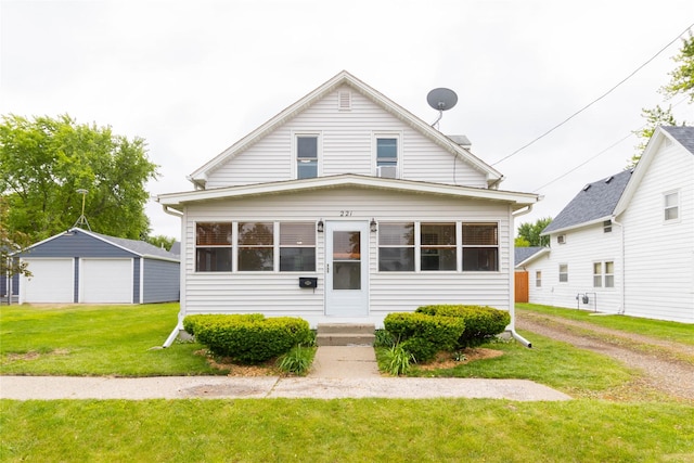 221 W Division St, Colfax, IA 50054 - view of front of property featuring a detached garage, a front yard, and an outdoor structure