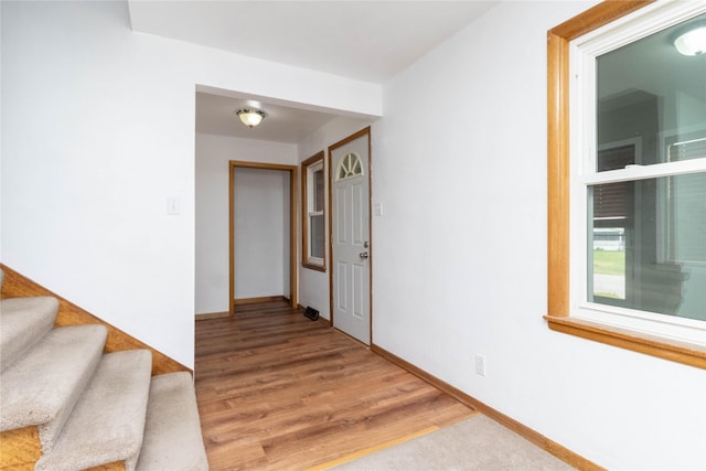 221 W Division St, Colfax, IA 50054 - foyer entrance featuring baseboards, light wood-style floors, and stairs