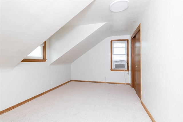 221 W Division St, Colfax, IA 50054 - bonus room with lofted ceiling, light carpet, cooling unit, and baseboards