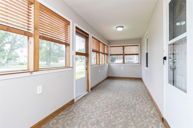 221 W Division St, Colfax, IA 50054 - unfurnished sunroom featuring carpet and baseboards