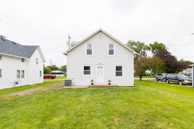 221 W Division St, Colfax, IA 50054 - rear view of property with central AC unit and a lawn