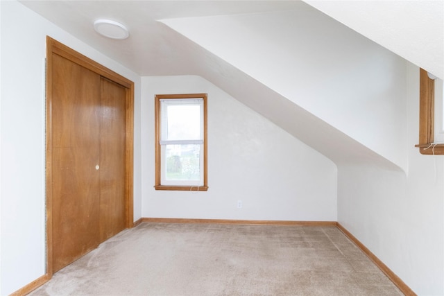 221 W Division St, Colfax, IA 50054 - bonus room featuring light colored carpet, vaulted ceiling, and baseboards