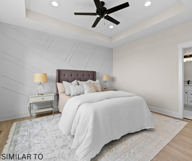 4641 179th St, Urbandale, IA 50323 - bedroom featuring recessed lighting, a raised ceiling, wood finished floors, ensuite bathroom, and a decorative wall