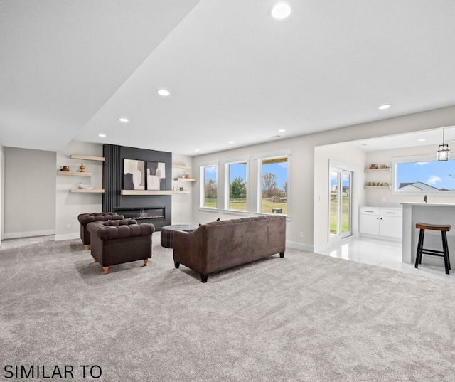 4641 179th St, Urbandale, IA 50323 - living area featuring recessed lighting, a glass covered fireplace, baseboards, light colored carpet, and healthy amount of natural light