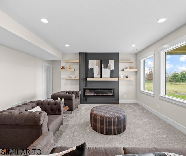 4641 179th St, Urbandale, IA 50323 - living room with recessed lighting, carpet flooring, a glass covered fireplace, and baseboards