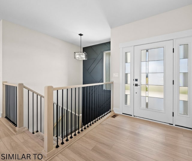 4641 179th St, Urbandale, IA 50323 - foyer with wood finished floors and a chandelier