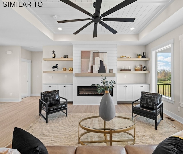 4641 179th St, Urbandale, IA 50323 - living room featuring a raised ceiling, light wood finished floors, and wooden ceiling