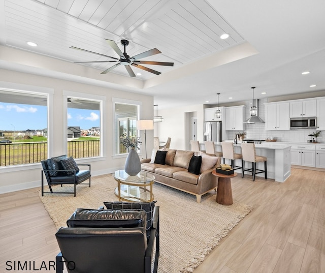 4641 179th St, Urbandale, IA 50323 - living area featuring plenty of natural light, light wood-style flooring, a raised ceiling, ceiling fan, and recessed lighting