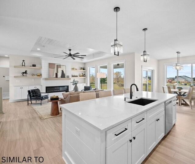 4641 179th St, Urbandale, IA 50323 - kitchen featuring a sink, dishwasher, a glass covered fireplace, white cabinets, and recessed lighting