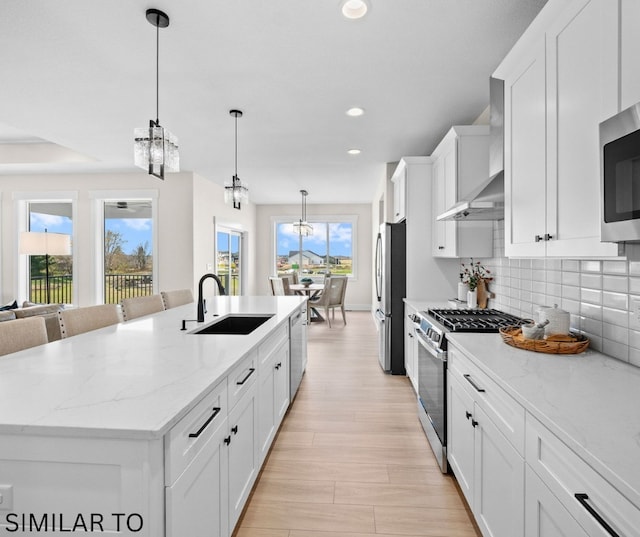 4641 179th St, Urbandale, IA 50323 - kitchen with a sink, stainless steel appliances, recessed lighting, a center island with sink, and white cabinets