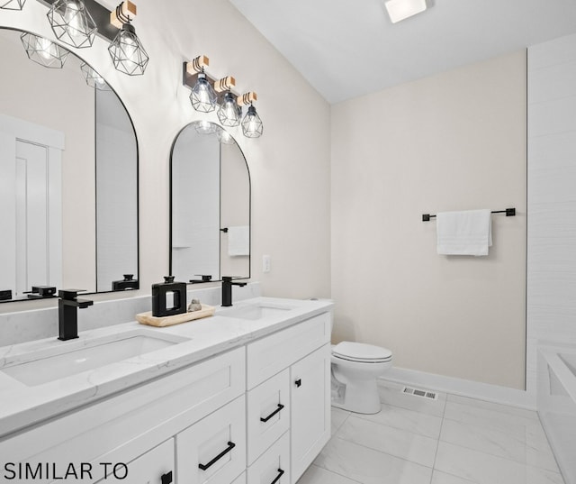 4641 179th St, Urbandale, IA 50323 - full bath featuring double vanity, marble look tiles, toilet, and baseboards