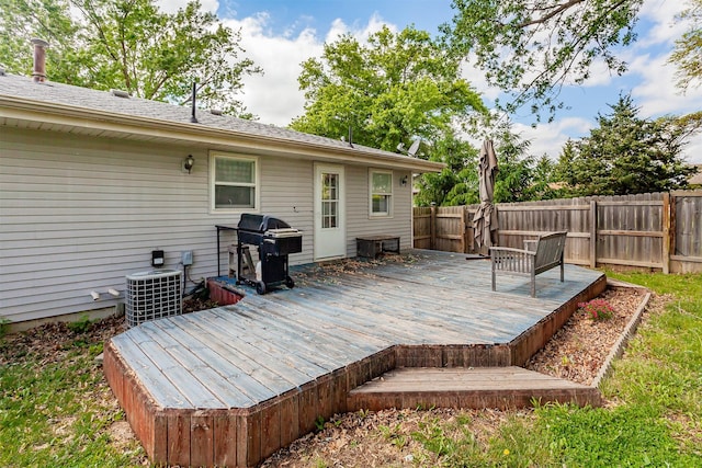 1406 110th Pl, Knoxville, IA 50138 - wooden terrace with area for grilling, a fenced backyard, and central AC unit