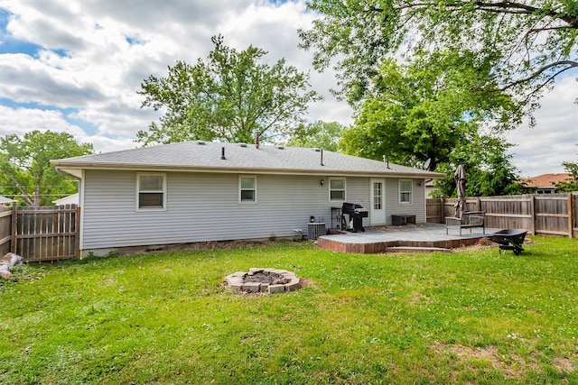 1406 110th Pl, Knoxville, IA 50138 - back of property featuring an outdoor fire pit, a patio, and central AC
