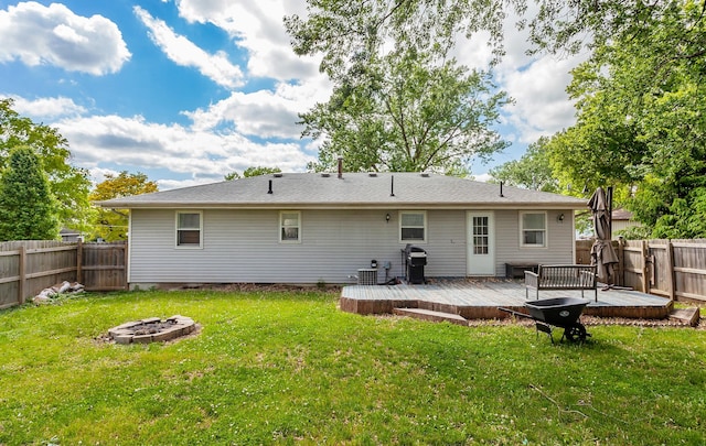 1406 110th Pl, Knoxville, IA 50138 - back of house with an outdoor fire pit and a wooden deck