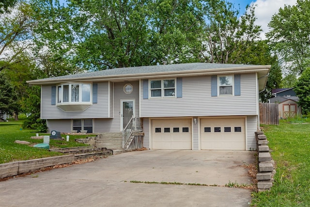 1406 110th Pl, Knoxville, IA 50138 - raised ranch featuring an attached garage, concrete driveway, and a front lawn