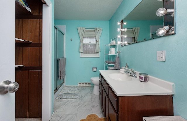1406 110th Pl, Knoxville, IA 50138 - bathroom with vanity, a stall shower, marble finish flooring, and toilet