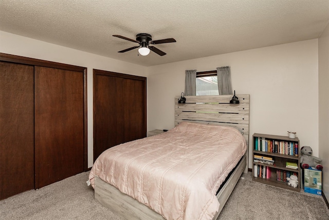 1406 110th Pl, Knoxville, IA 50138 - carpeted bedroom with two closets and ceiling fan