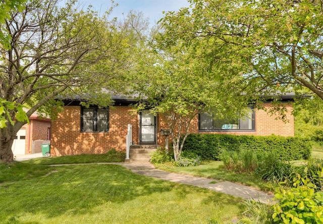 936 15th St, West Des Moines, IA 50265 - obstructed view of property with brick siding and a front yard