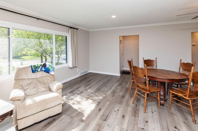 936 15th St, West Des Moines, IA 50265 - dining area featuring ornamental molding, plenty of natural light, wood finished floors, baseboards, and recessed lighting