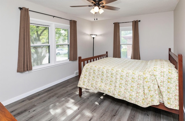 936 15th St, West Des Moines, IA 50265 - bedroom with wood finished floors, multiple windows, and baseboards