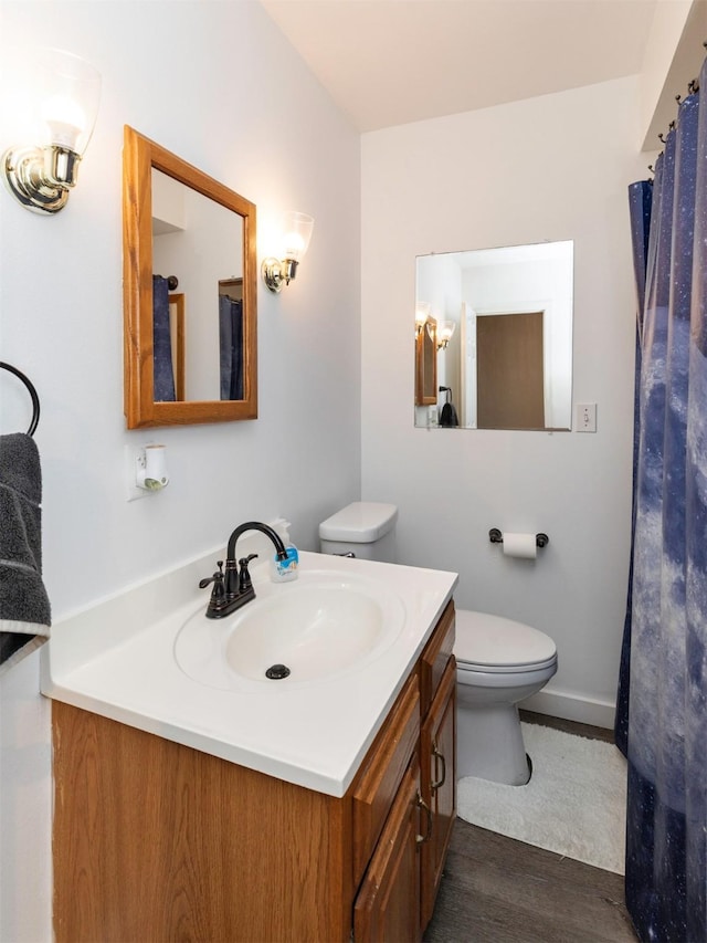 936 15th St, West Des Moines, IA 50265 - bathroom featuring vanity, toilet, wood finished floors, and baseboards