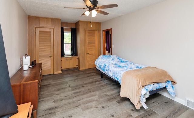 936 15th St, West Des Moines, IA 50265 - bedroom featuring wood finished floors, a textured ceiling, and a ceiling fan