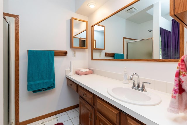 936 15th St, West Des Moines, IA 50265 - bathroom featuring a shower stall, vanity, tile patterned floors, and baseboards
