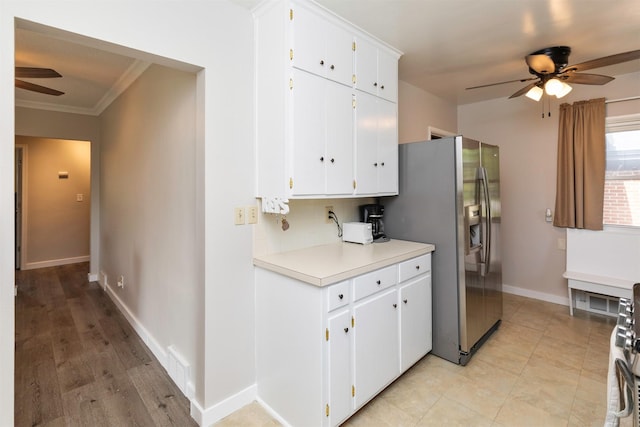 936 15th St, West Des Moines, IA 50265 - kitchen with a ceiling fan, appliances with stainless steel finishes, crown molding, light countertops, and white cabinets