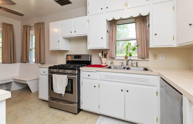 936 15th St, West Des Moines, IA 50265 - kitchen with stainless steel appliances, a sink, backsplash, and light countertops