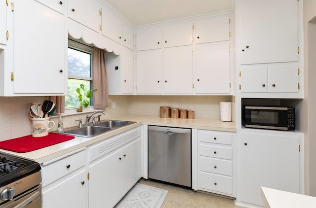 936 15th St, West Des Moines, IA 50265 - kitchen with appliances with stainless steel finishes, a sink, white cabinetry, light countertops, and decorative backsplash