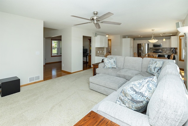 5525 SE 29th Ct, Des Moines, IA 50320 - living area with carpet floors, baseboards, ceiling fan, and recessed lighting