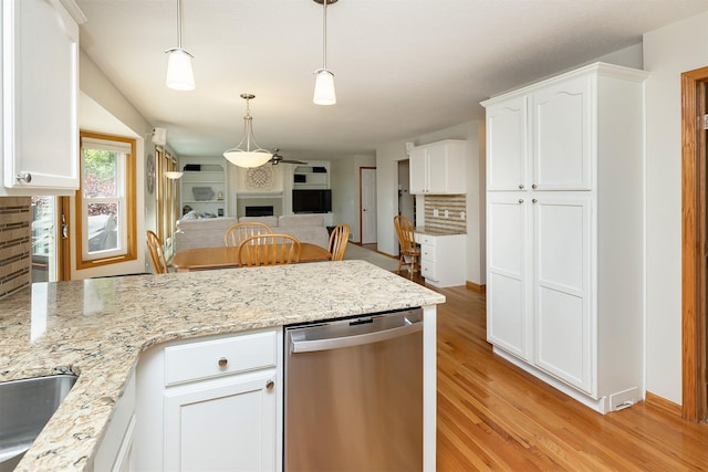 5525 SE 29th Ct, Des Moines, IA 50320 - kitchen featuring dishwasher, a peninsula, white cabinetry, and open floor plan